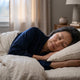 Woman sleeping peacefully in linen bedding at dawn — magnesium glycinate and sleep